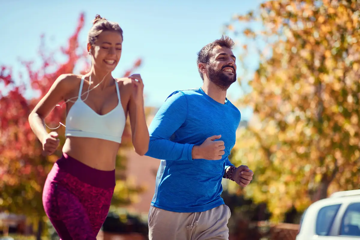 Young man and woman jogging at the park. healthy lifestyle