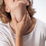 Sore Throat Close Up Woman Holding Neck Pain On White Background Studio